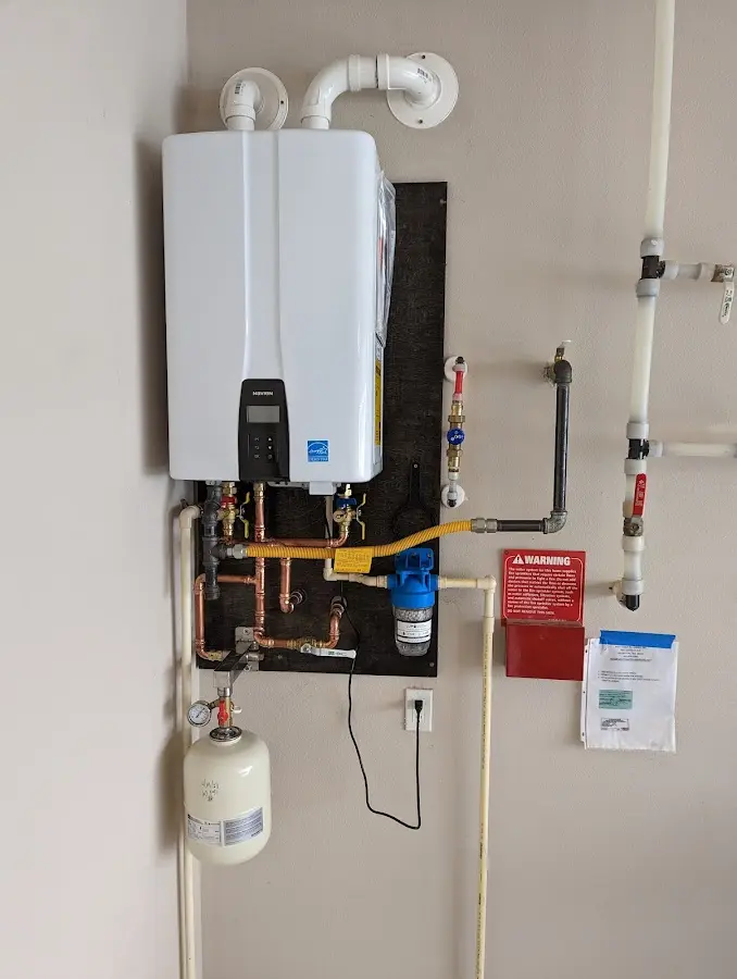 Professional plumber installing copper piping in a The Hammocks home